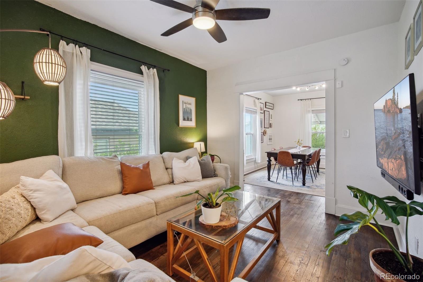 60 Perry Street Denver, CO 80219 - Photo 8 of 43 a living room with furniture a chandelier and a flat screen tv
