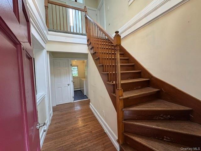 74 South Airmont Road Suffern, NY 10901 - Photo 4 of 42 Entryway featuring wood-finish flooring, a grand staircase with wood balusters, and a second-story landing with an open railing