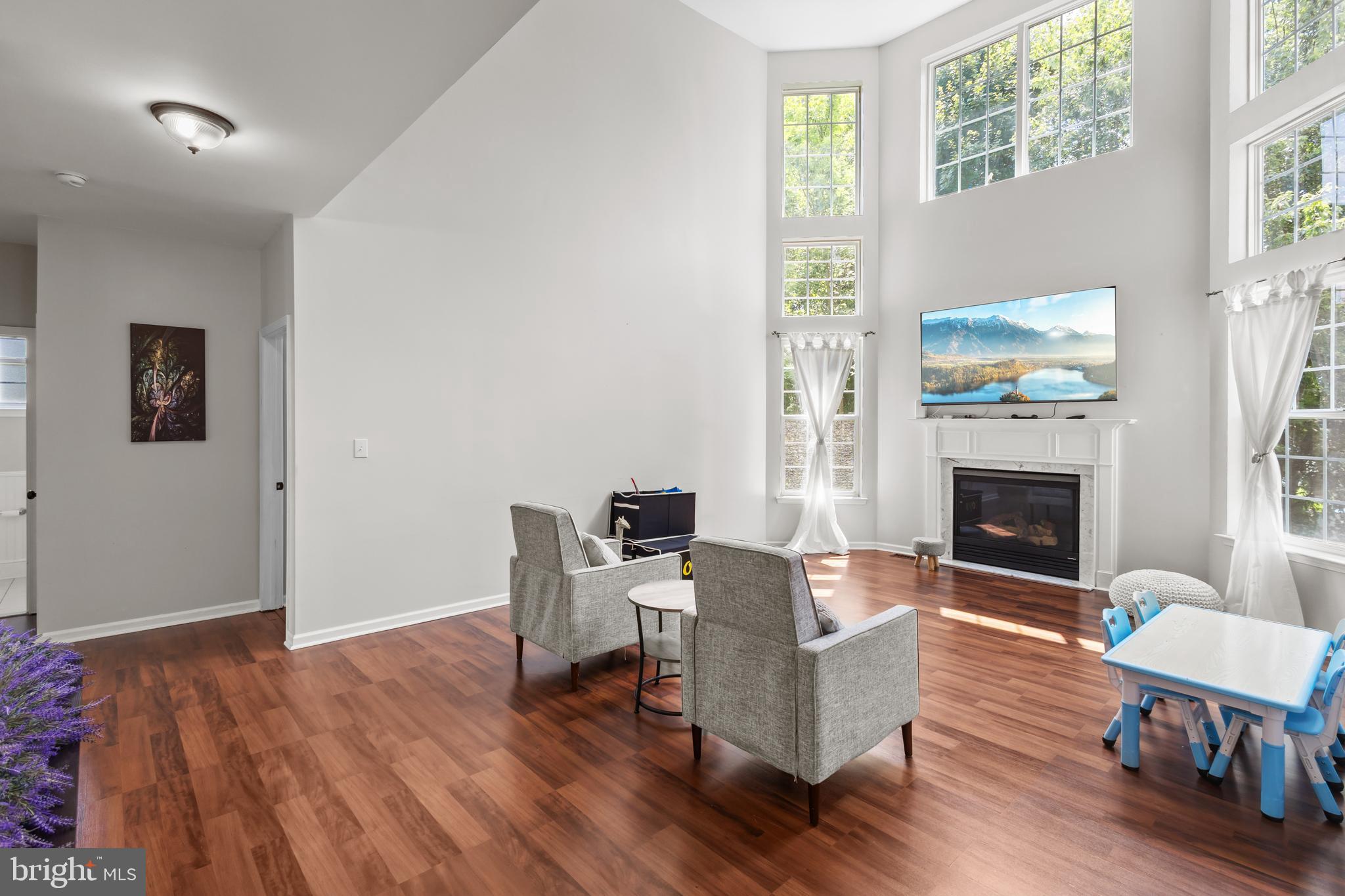 2603 Valhalla Road Vineland, NJ 08361 - Photo 12 of 43 a living room with furniture a fireplace and a large window