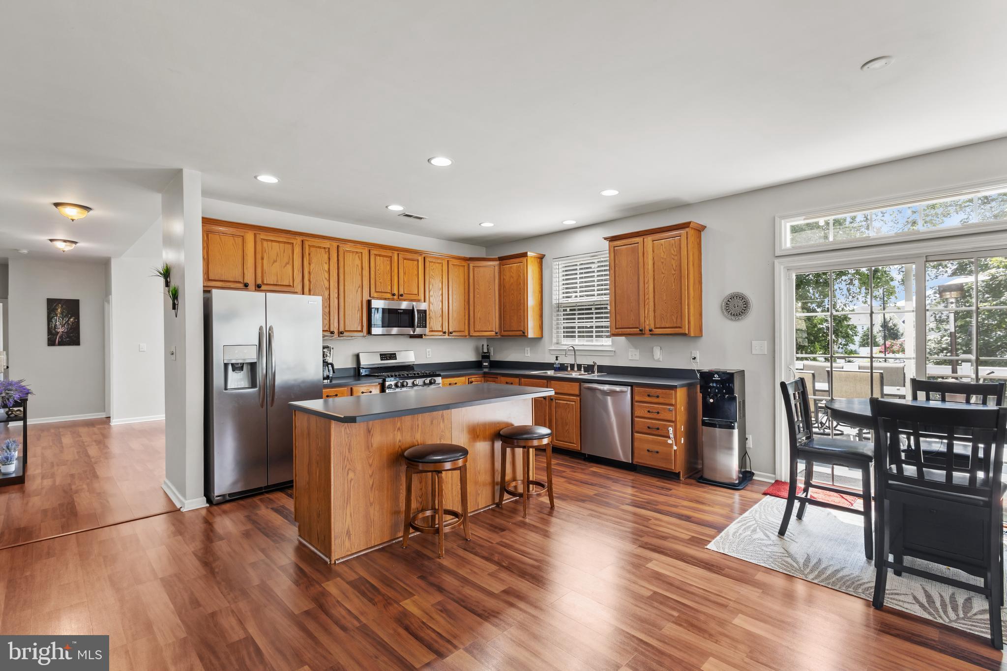 2603 Valhalla Road Vineland, NJ 08361 - Photo 5 of 43 a kitchen with stainless steel appliances granite countertop a refrigerator a stove top oven and a dining table with wooden floor