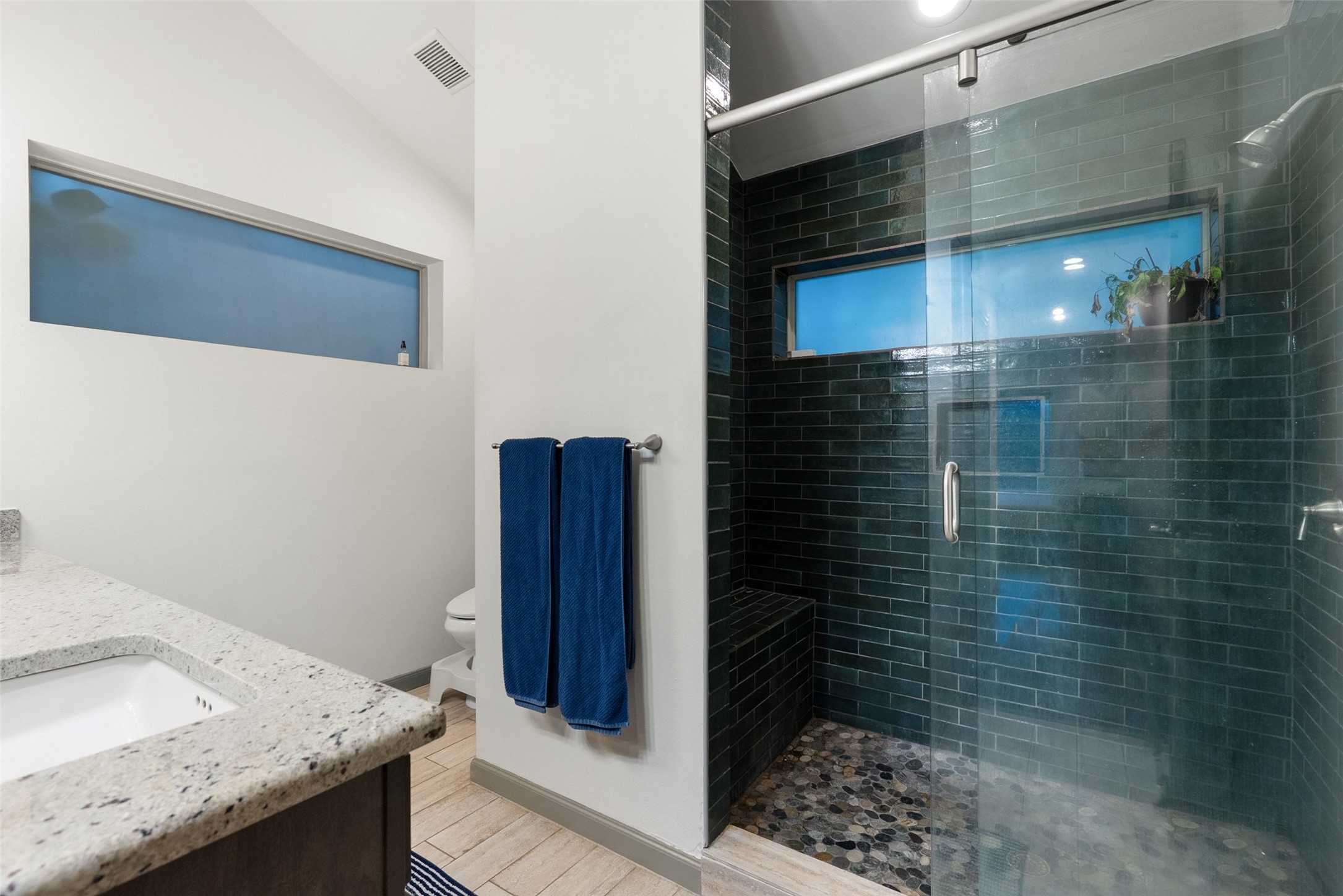 1158 Ridgeway Drive, Unit A Austin, TX 78702 - Photo 13 of 28 A well-appointed bathroom features a spacious shower and a vanity with granite counters.