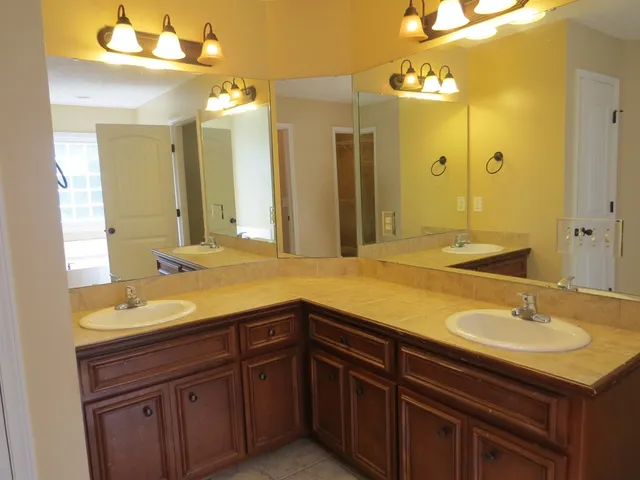 a bathroom with a sink double vanity granite and a mirror