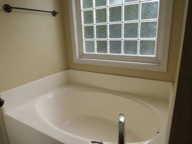 a bath tub sitting next to a window