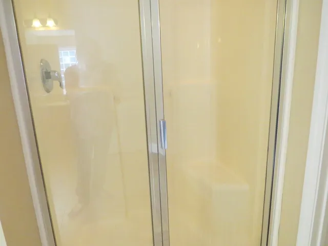 a bathroom with a glass shower door