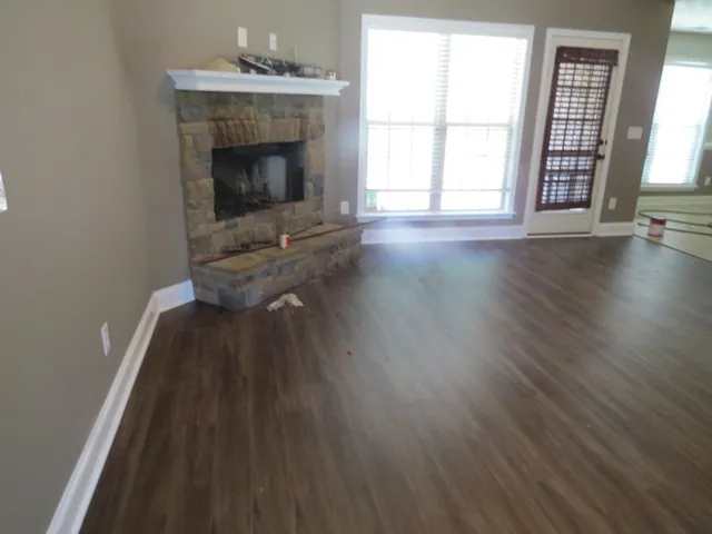 wooden floor in an empty room with a fireplace