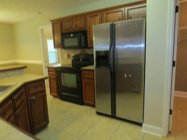a kitchen with a refrigerator and a sink