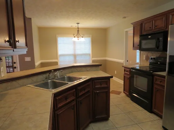 a kitchen with a sink and a stove top oven