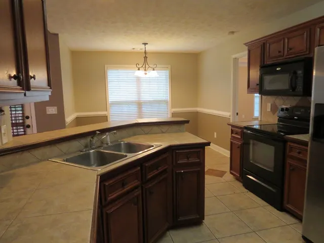 a kitchen with a sink and a stove top oven