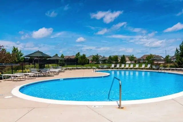 a view of a swimming pool with lounge chair