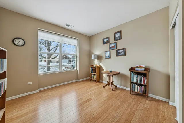 a view of an empty room with furniture and a window