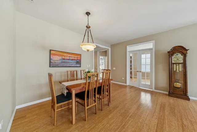 a view of a dining room with furniture wooden floor and chandelier