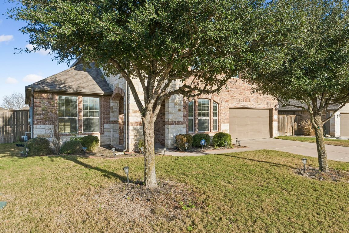 3900 Crispin Hall Lane Pflugerville, TX 78660 - Photo 2 of 31 a front view of a house with garden