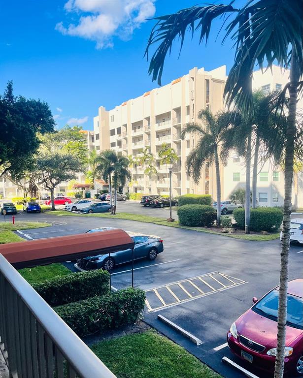 3910 Inverrary Boulevard, Unit 203B Lauderhill, FL 33319 - Photo 54 of 61 a view of a yard with cars