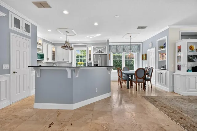 a living room with furniture and a kitchen area