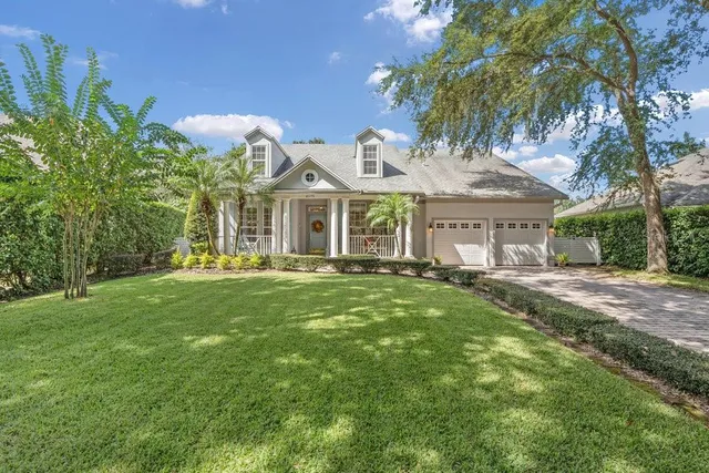 a view of a house with a yard and pathway