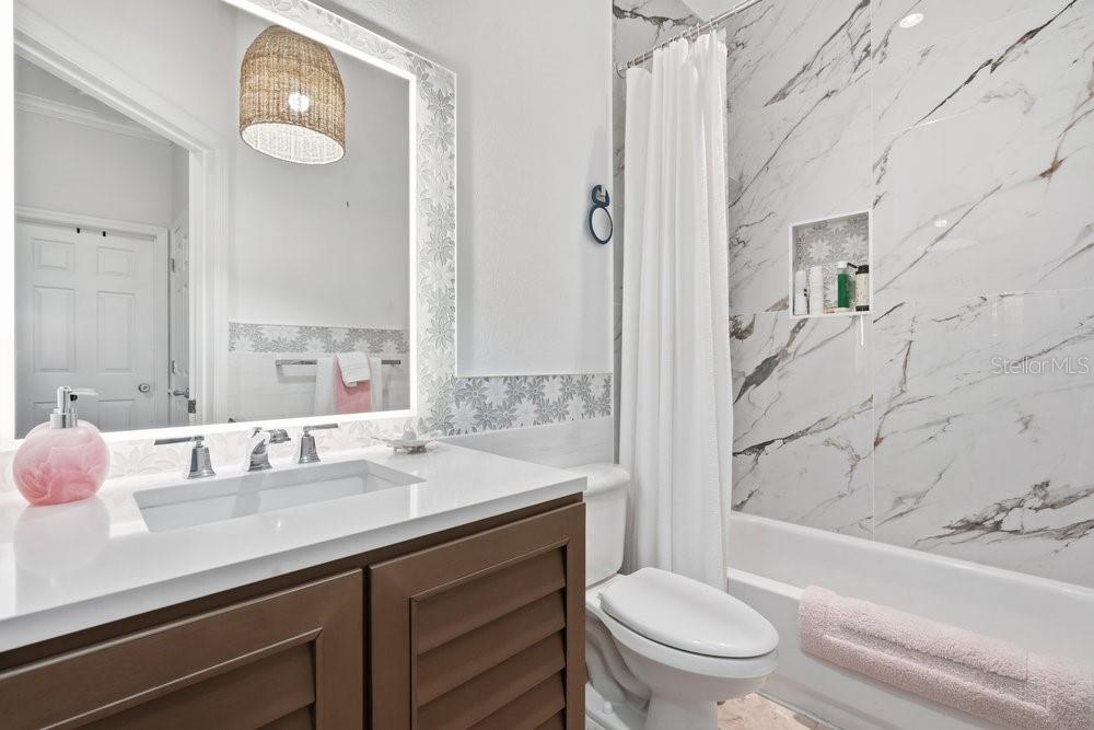 8375 Bowden Way Windermere, FL 34786 - Photo 28 of 62 a bathroom with a granite countertop sink toilet and shower