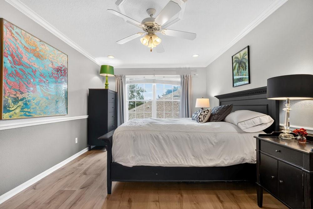 8375 Bowden Way Windermere, FL 34786 - Photo 36 of 62 a bedroom with a bed and dresser with wooden floor