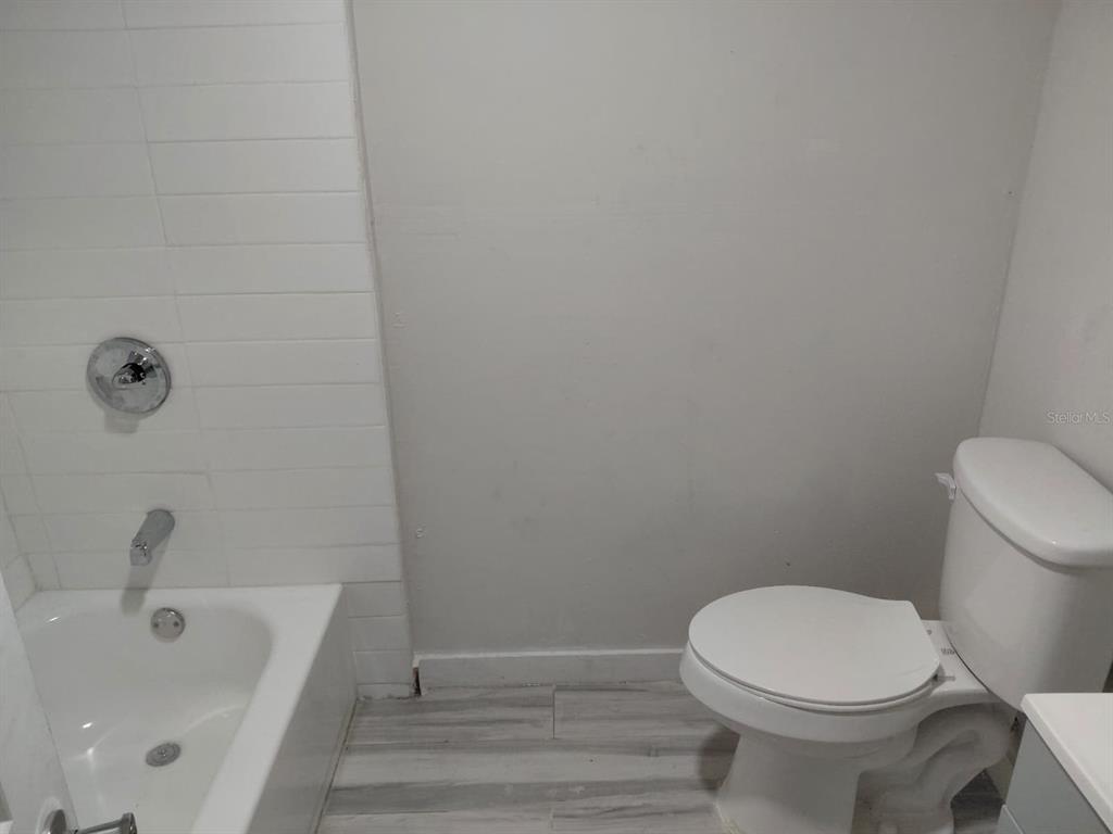 17405 Northeast 38th Lane Road Silver Springs, FL 34488 - Photo 12 of 25 a bathroom with a sink and a toilet