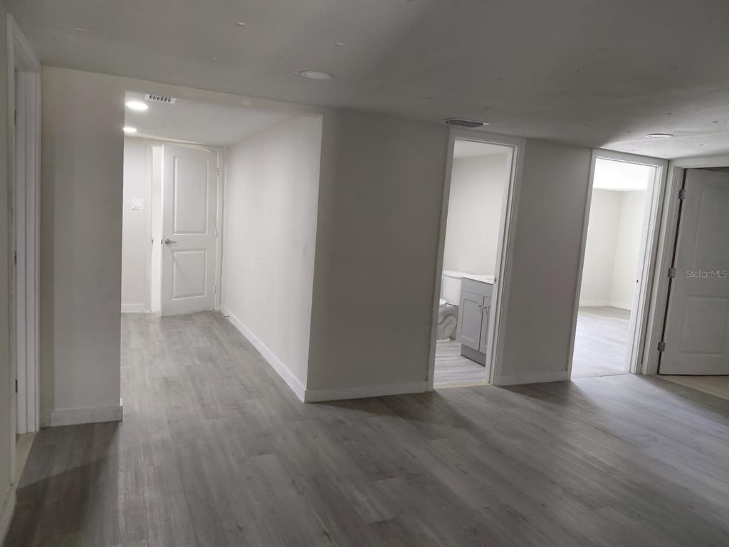 17405 Northeast 38th Lane Road Silver Springs, FL 34488 - Photo 16 of 25 a view of an empty room with wooden floor and a window