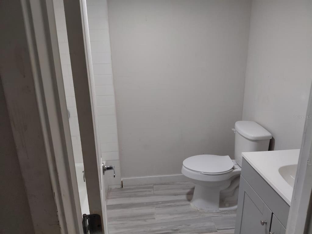 17405 Northeast 38th Lane Road Silver Springs, FL 34488 - Photo 17 of 25 a white toilet sitting next to a sink