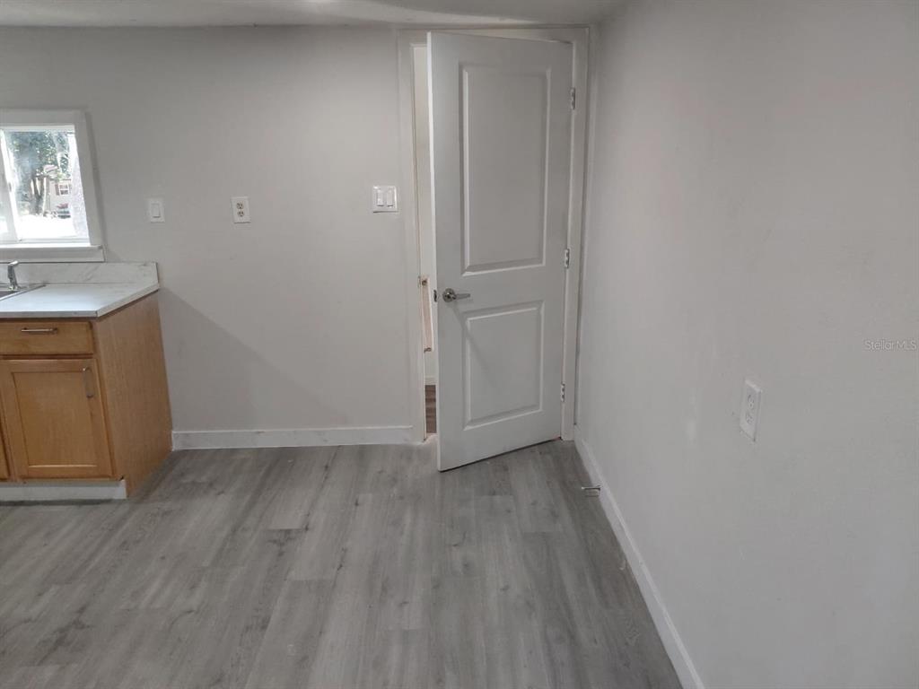 17405 Northeast 38th Lane Road Silver Springs, FL 34488 - Photo 18 of 25 a view of an empty room with wooden floor and a window