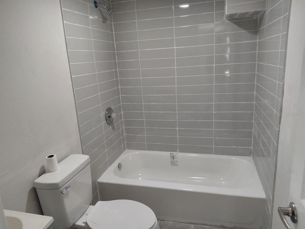 17405 Northeast 38th Lane Road Silver Springs, FL 34488 - Photo 21 of 25 a bathroom with a bathtub and toilet