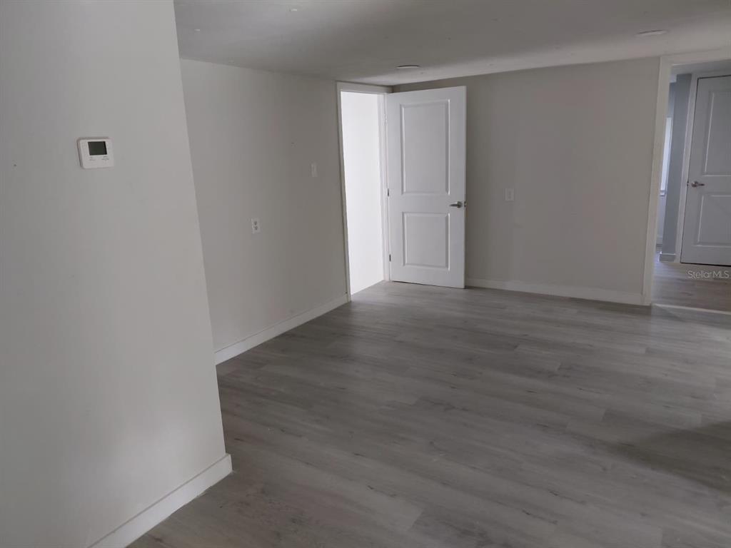 17405 Northeast 38th Lane Road Silver Springs, FL 34488 - Photo 25 of 25 a view of an empty room with wooden floor and closet