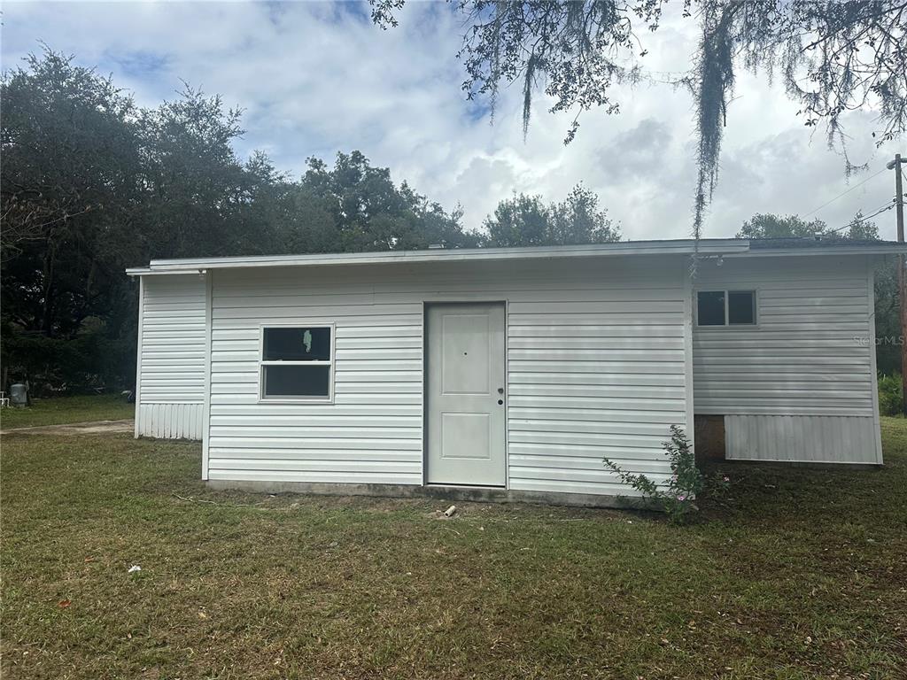 17405 Northeast 38th Lane Road Silver Springs, FL 34488 - Photo 5 of 25 a view of a white house with a yard