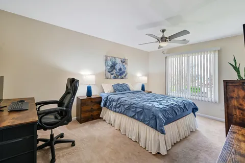 a bedroom with a bed window and a desk