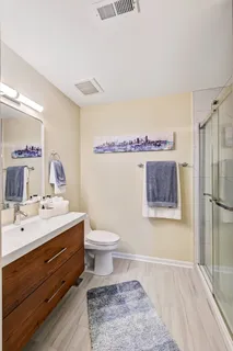 a bathroom with a sink mirror and toilet