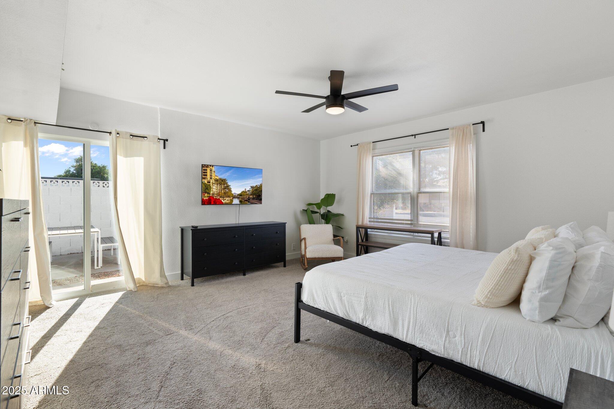 1759 North Spring Circle Mesa, AZ 85203 - Photo 40 of 69 a bedroom with a bed and a chandelier