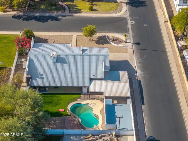 an aerial view of a house with garden space and street view