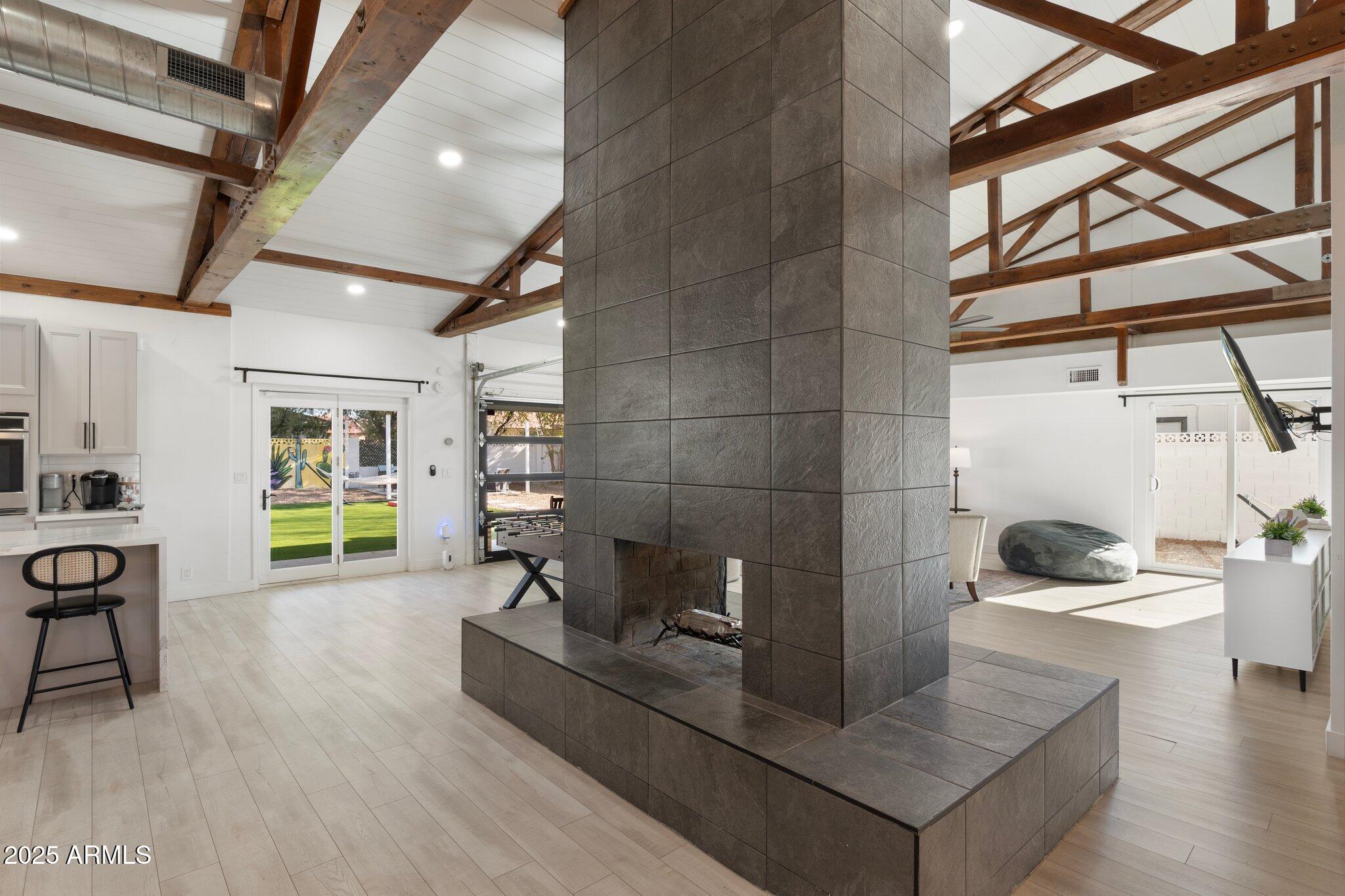 1759 North Spring Circle Mesa, AZ 85203 - Photo 53 of 69 a living room with a couch and a dining table with wooden floor