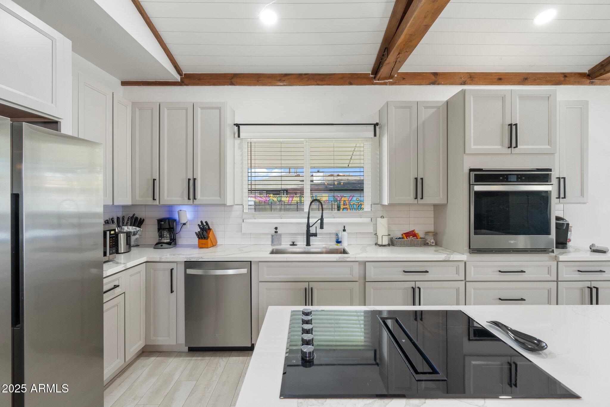 1759 North Spring Circle Mesa, AZ 85203 - Photo 64 of 69 a kitchen with white cabinets sink and stainless steel appliances