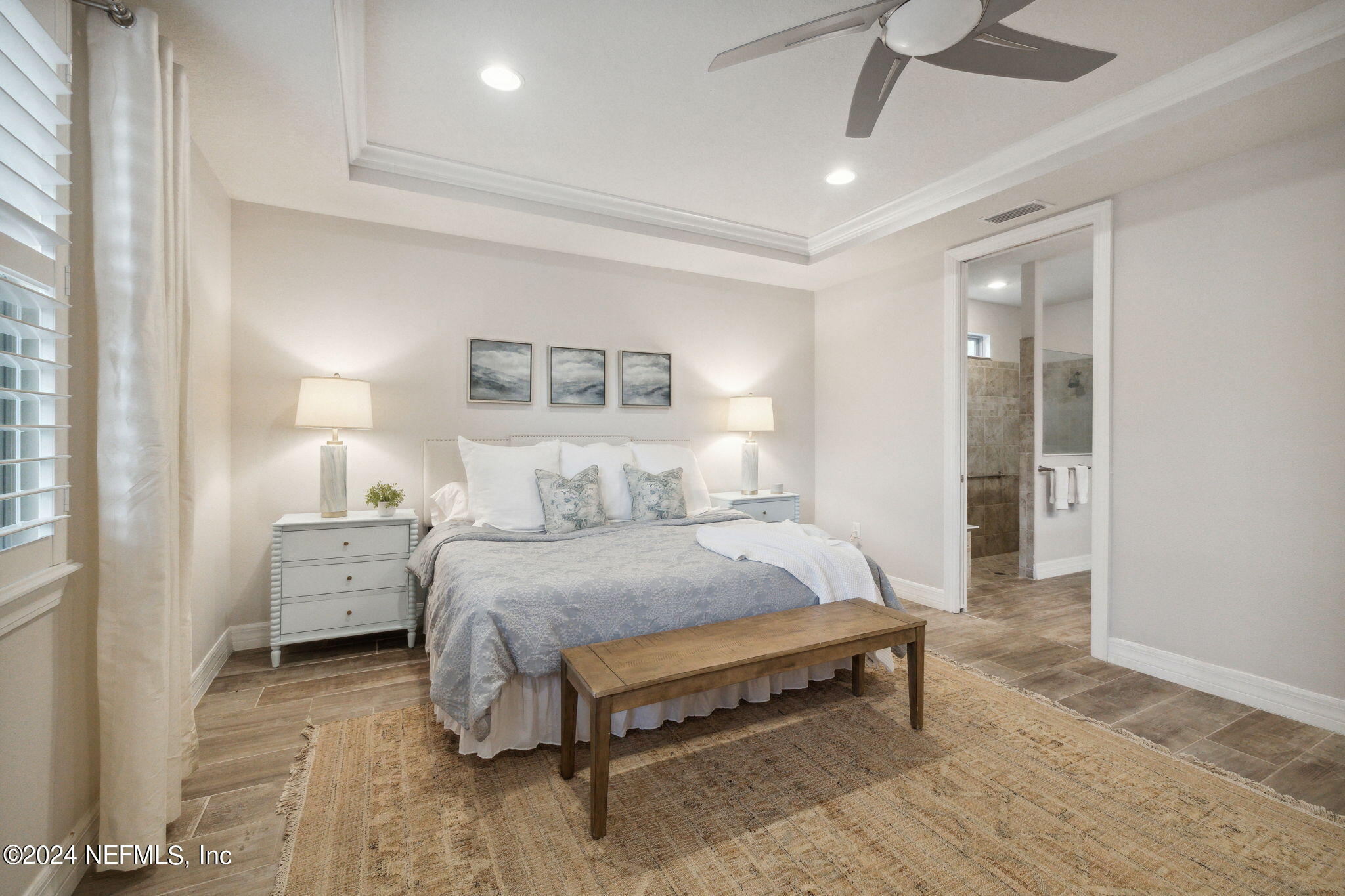 376 Eagle Pass Drive Ponte Vedra, FL 32081 - Photo 16 of 52 a bedroom with a bed and a chandelier