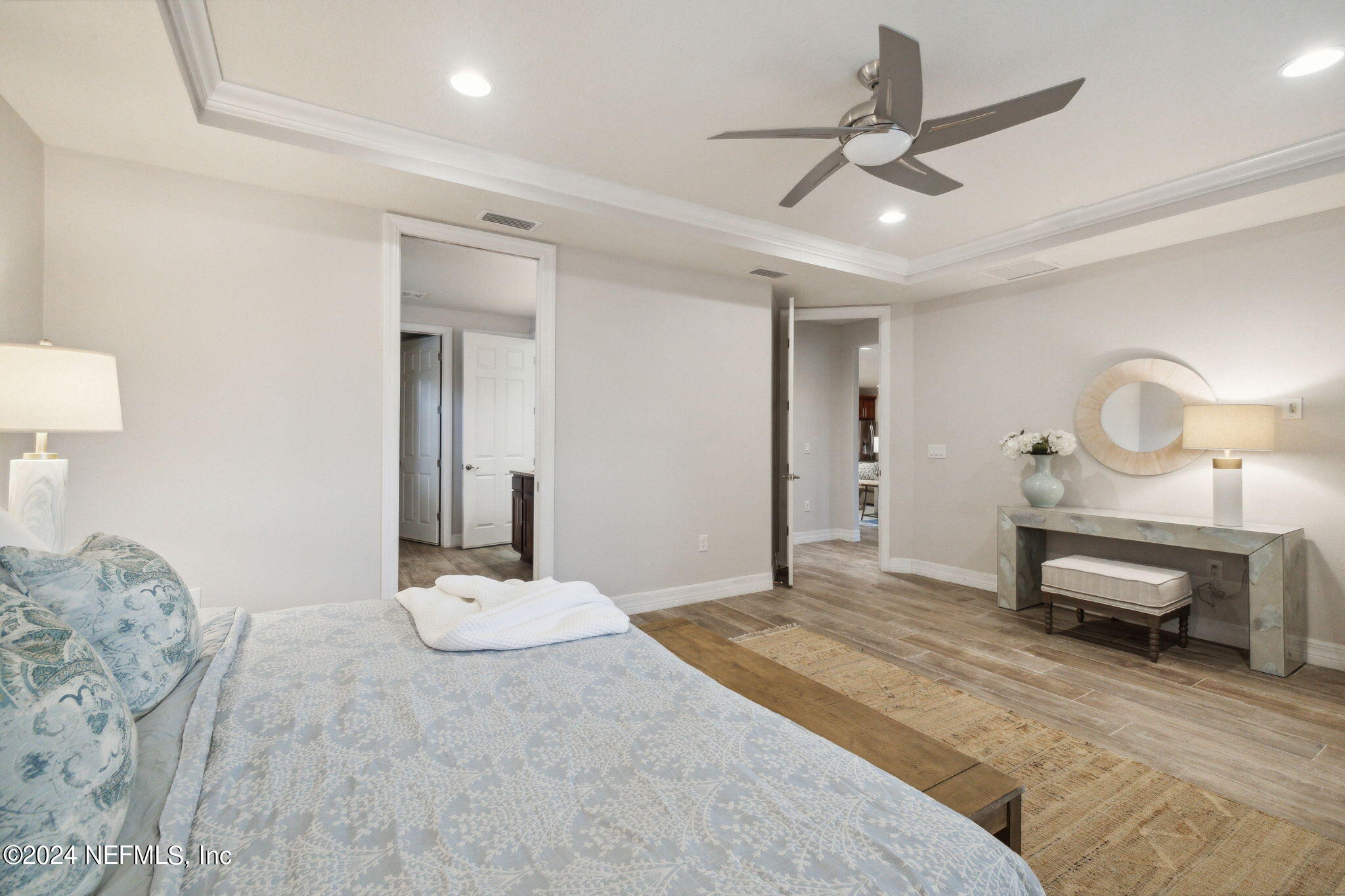 376 Eagle Pass Drive Ponte Vedra, FL 32081 - Photo 17 of 52 a bedroom with a bed a chandelier and a dresser