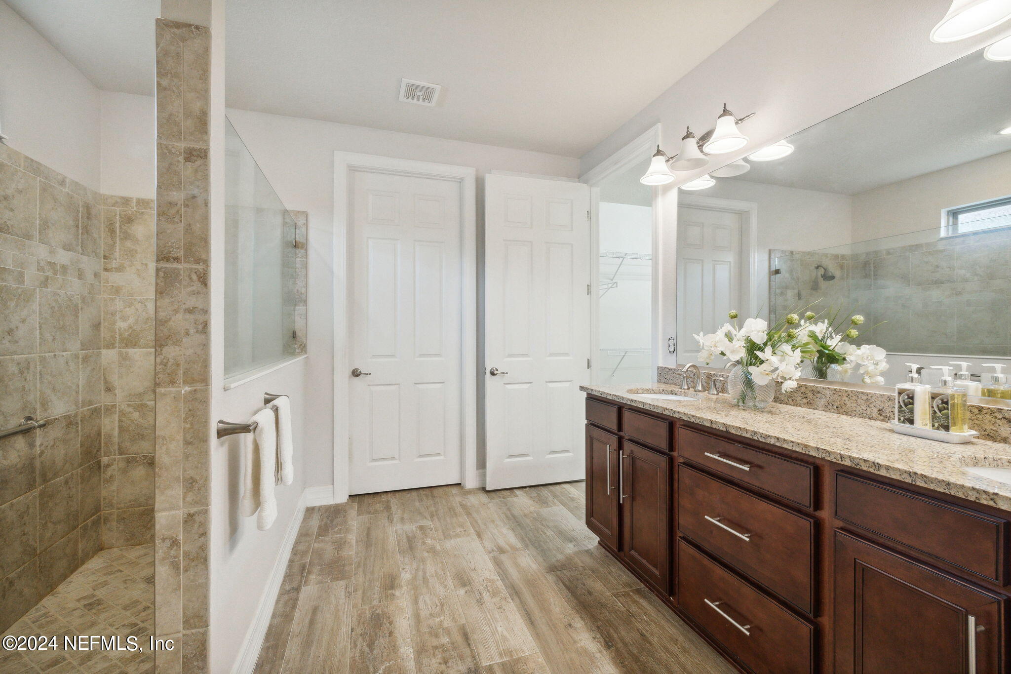376 Eagle Pass Drive Ponte Vedra, FL 32081 - Photo 18 of 52 a spacious bathroom with a granite countertop sink a mirror and a shower
