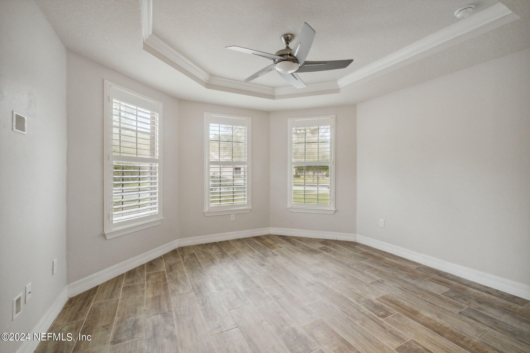 376 Eagle Pass Drive Ponte Vedra, FL 32081 - Photo 24 of 52 a view of an empty room with wooden floor and a window