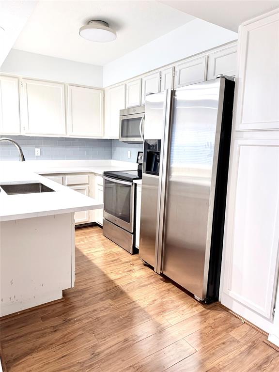 4411 Gilbert Avenue, Unit 10 Dallas, TX 75219 - Photo 3 of 11 a kitchen with a refrigerator sink and microwave