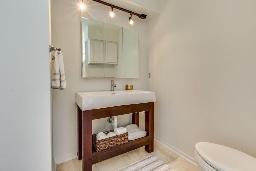 4411 Gilbert Avenue, Unit 10 Dallas, TX 75219 - Photo 7 of 11 a bathroom with a sink toilet and mirror