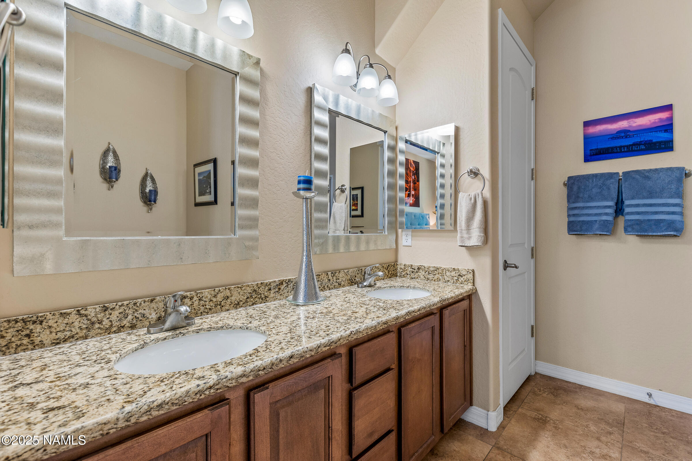 3239 Merryvale Lane Flagstaff, AZ 86005 - Photo 17 of 40 a bathroom with a granite countertop sink and a mirror