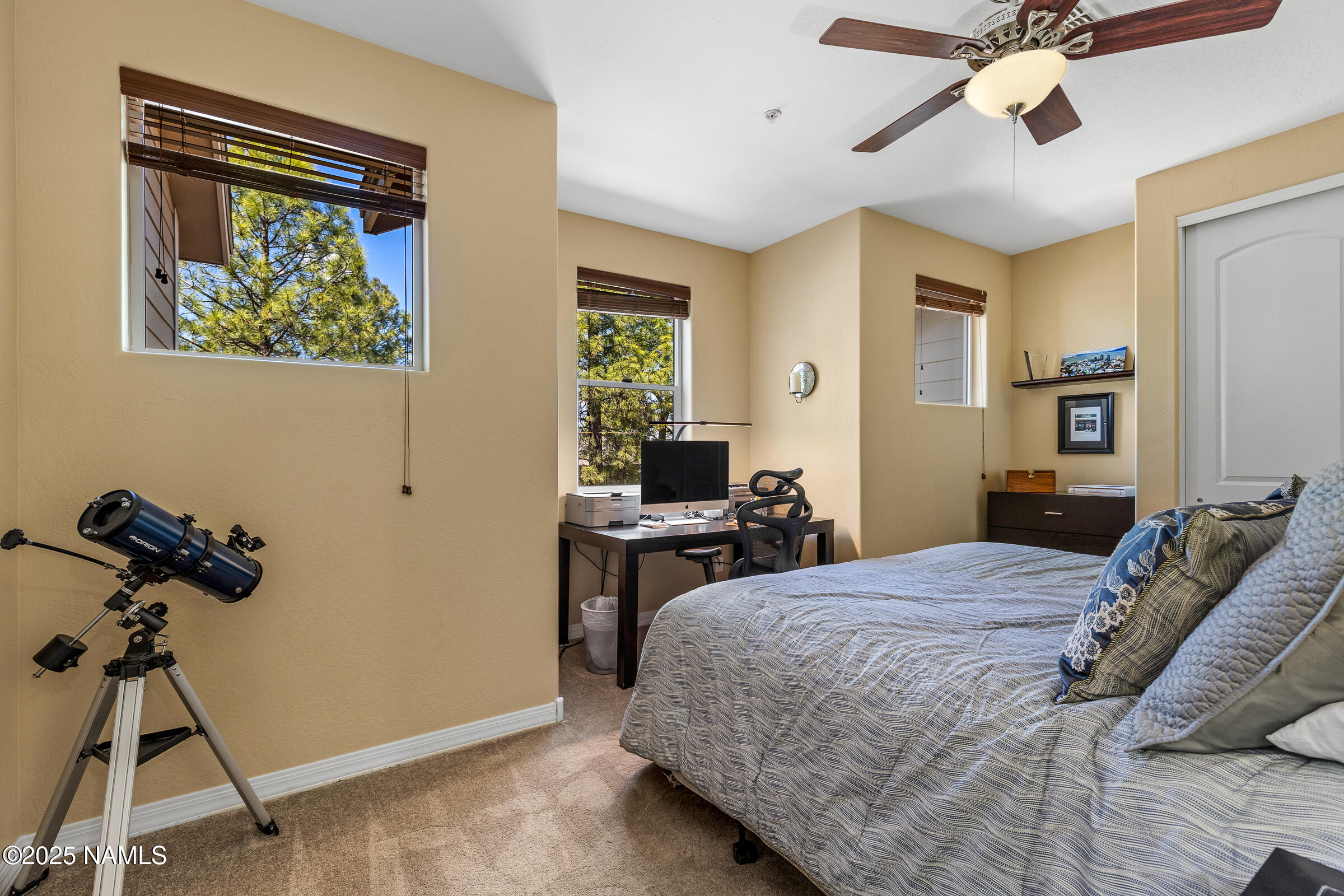 3239 Merryvale Lane Flagstaff, AZ 86005 - Photo 20 of 40 a bedroom with a bed and a chandelier