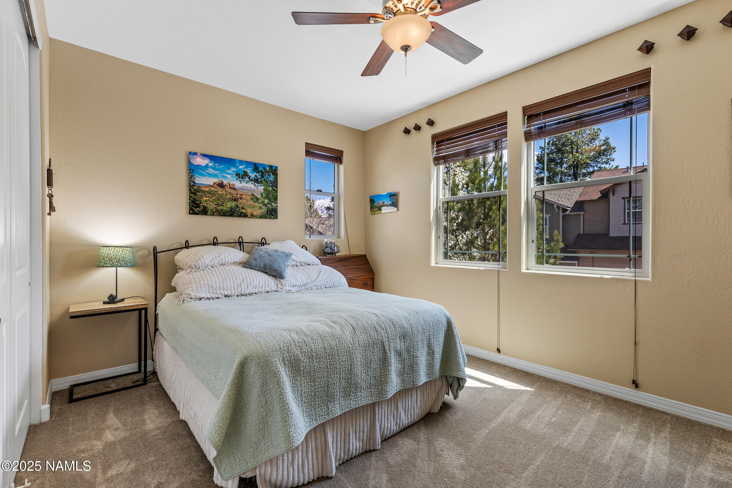 3239 Merryvale Lane Flagstaff, AZ 86005 - Photo 22 of 40 a bedroom with a bed and a painting on the wall