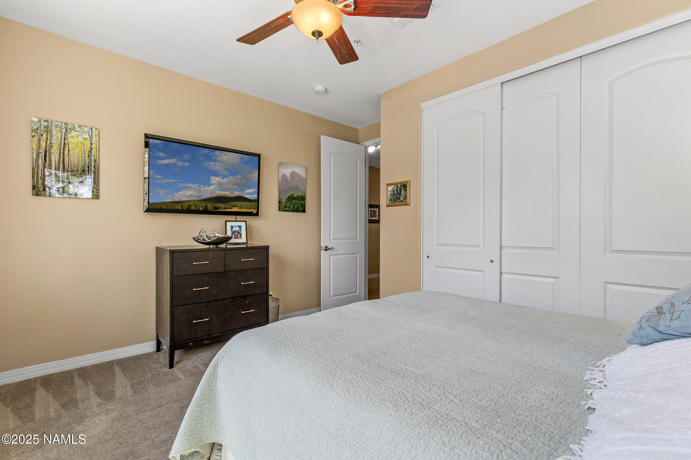 3239 Merryvale Lane Flagstaff, AZ 86005 - Photo 24 of 40 a bedroom with a bed and a flat screen tv