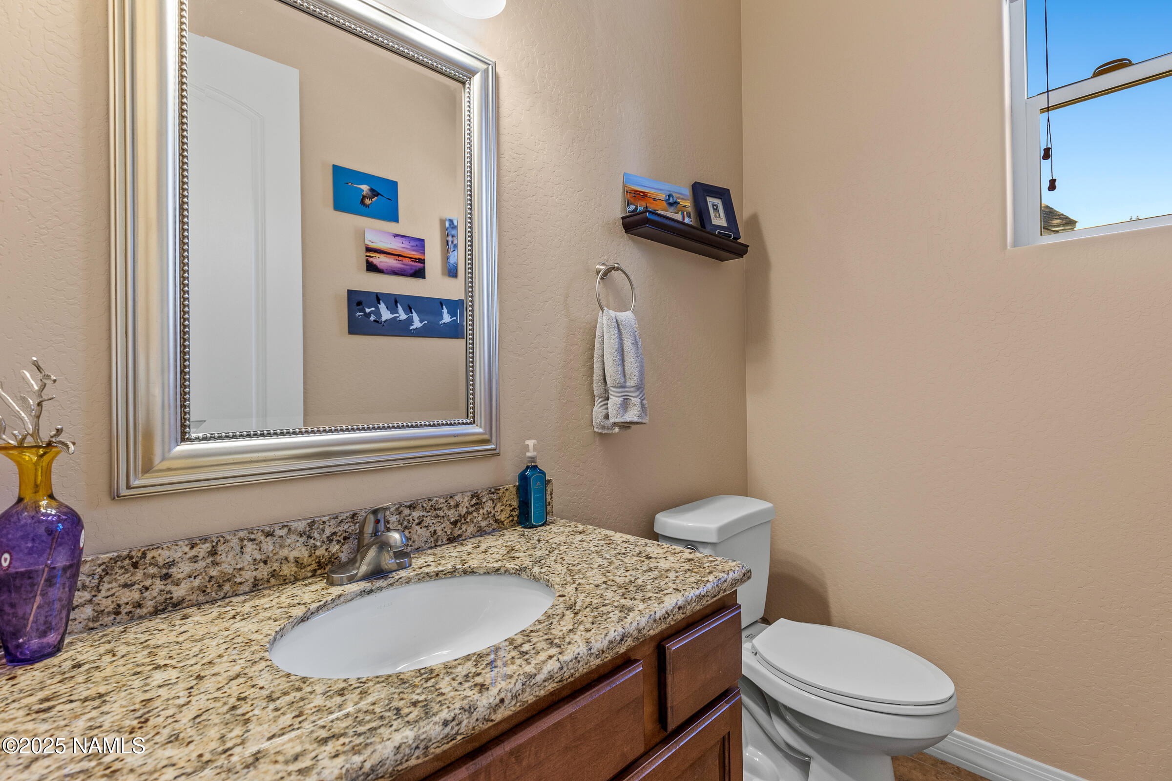 3239 Merryvale Lane Flagstaff, AZ 86005 - Photo 26 of 40 a bathroom with a granite countertop sink a toilet and a mirror