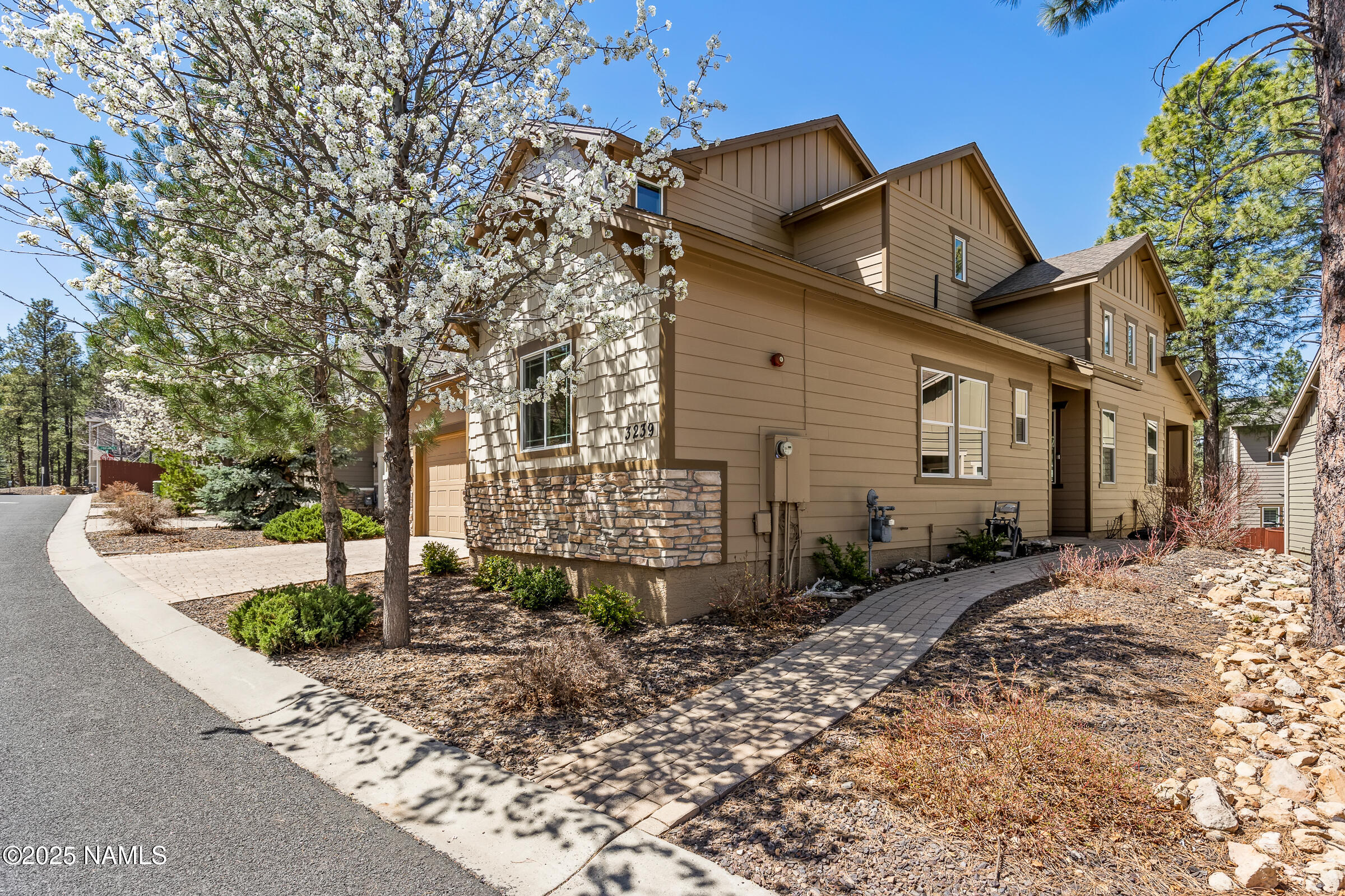 3239 Merryvale Lane Flagstaff, AZ 86005 - Photo 3 of 40 a front view of a house with garden