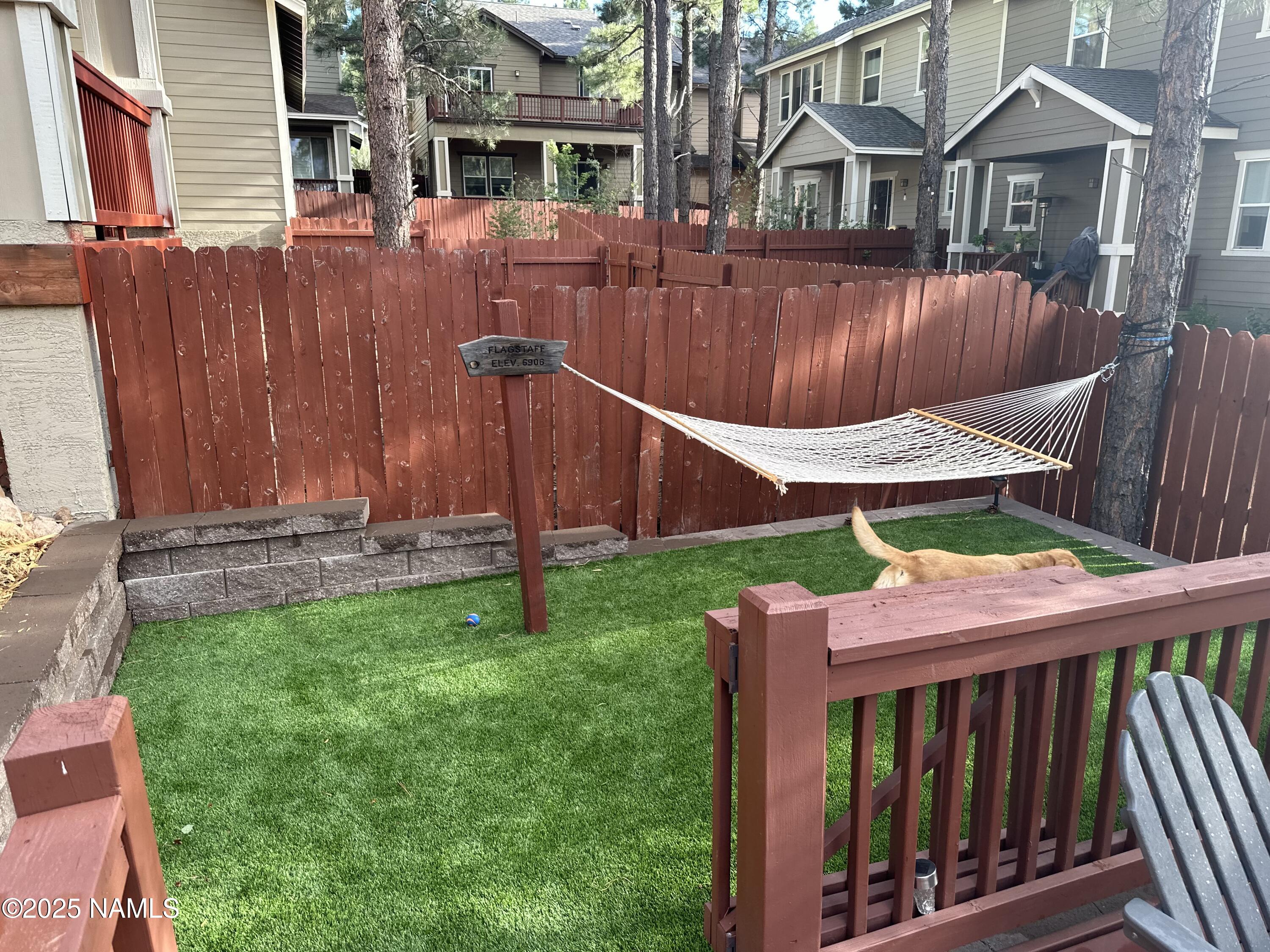 3239 Merryvale Lane Flagstaff, AZ 86005 - Photo 36 of 40 a view of a backyard with a deck and wooden fence