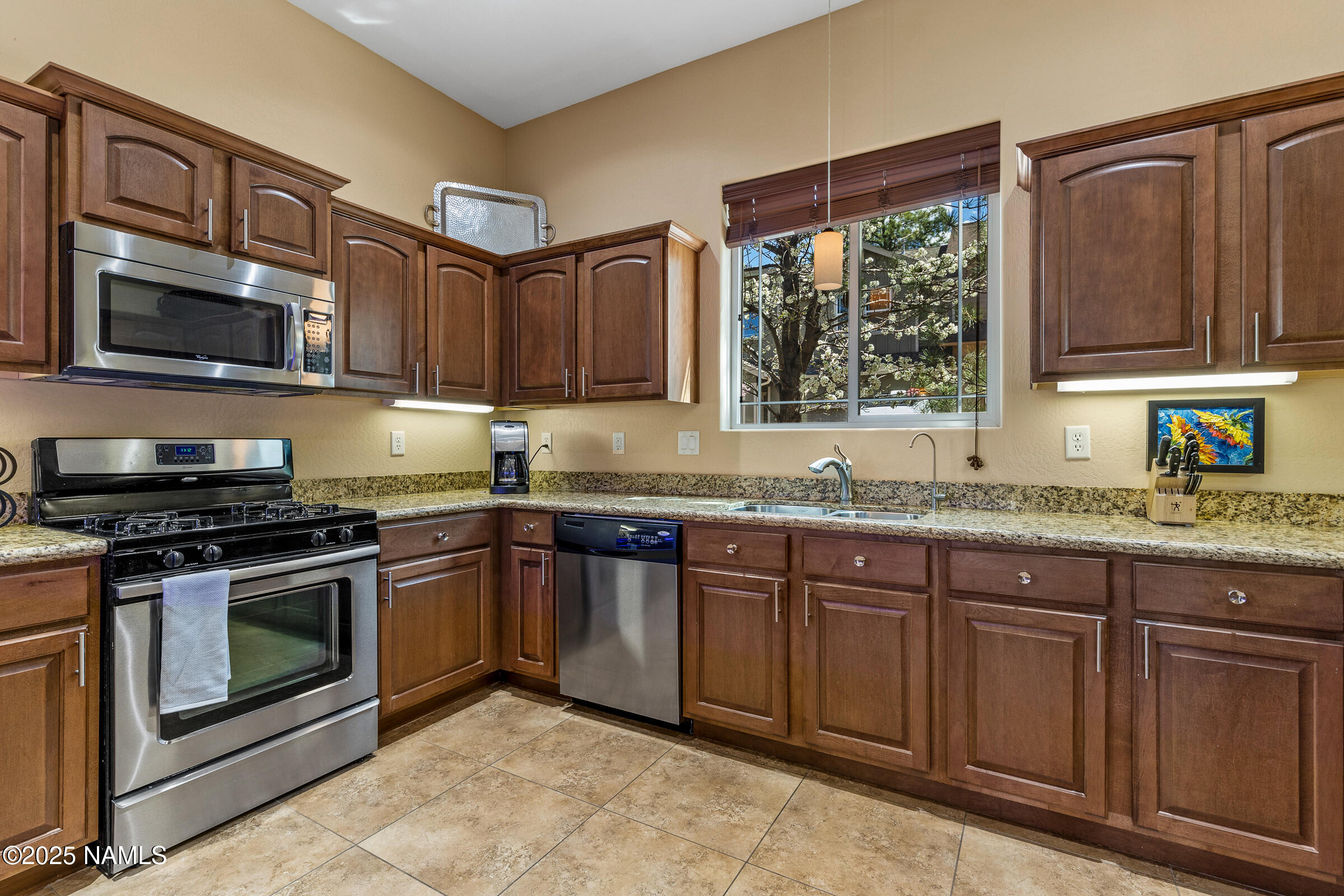 3239 Merryvale Lane Flagstaff, AZ 86005 - Photo 4 of 40 a kitchen with granite countertop a stove sink and microwave
