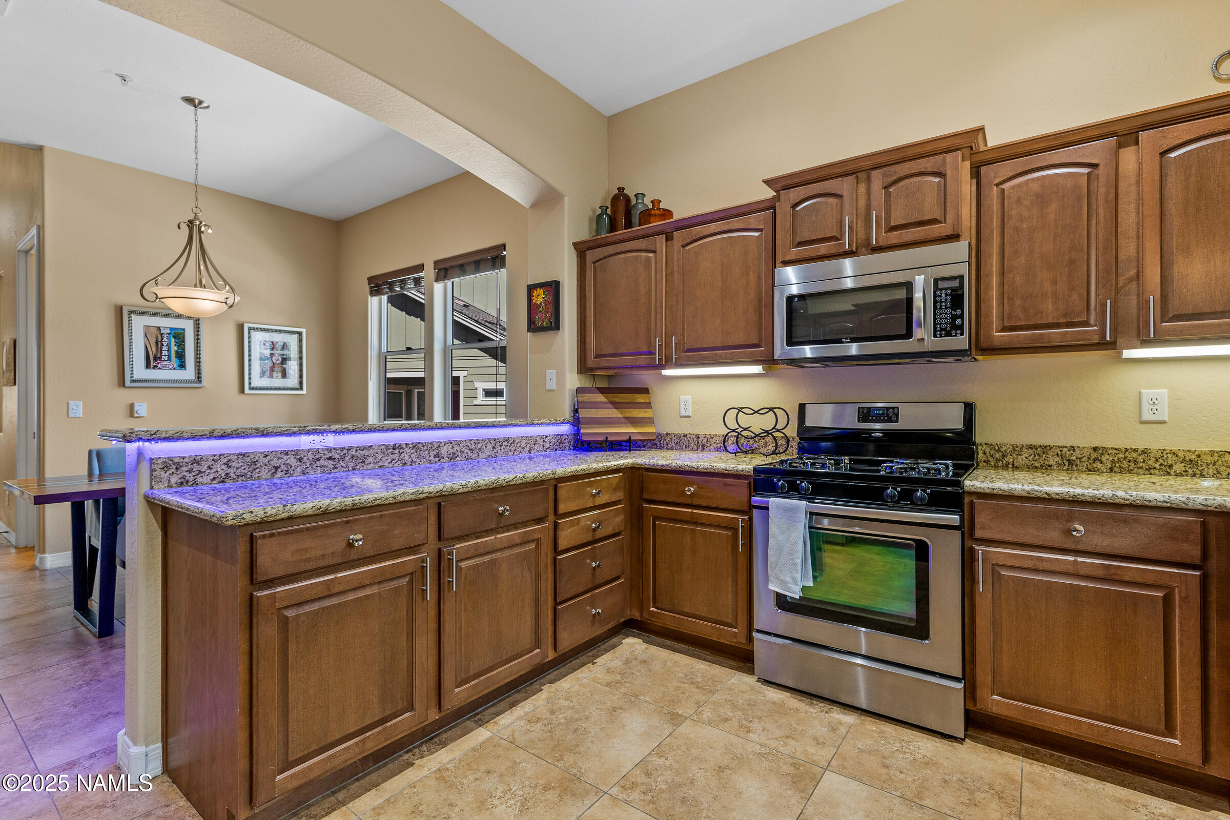 3239 Merryvale Lane Flagstaff, AZ 86005 - Photo 5 of 40 a kitchen with stainless steel appliances granite countertop a stove top oven a sink dishwasher and cabinets with wooden floor