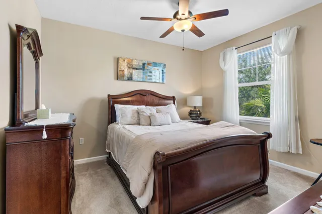 a bedroom with a bed a window and a chandelier